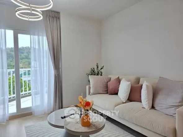 Elegant living room with modern decor and scenic balcony view