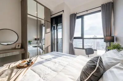 Bright and modern bedroom with large windows and city view