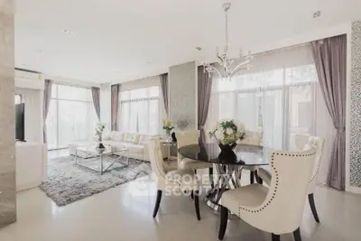 Luxurious open-plan living and dining area with elegant decor and ample natural light.