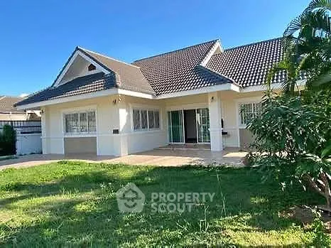 Charming single-story house with lush garden and spacious patio, perfect for family living.