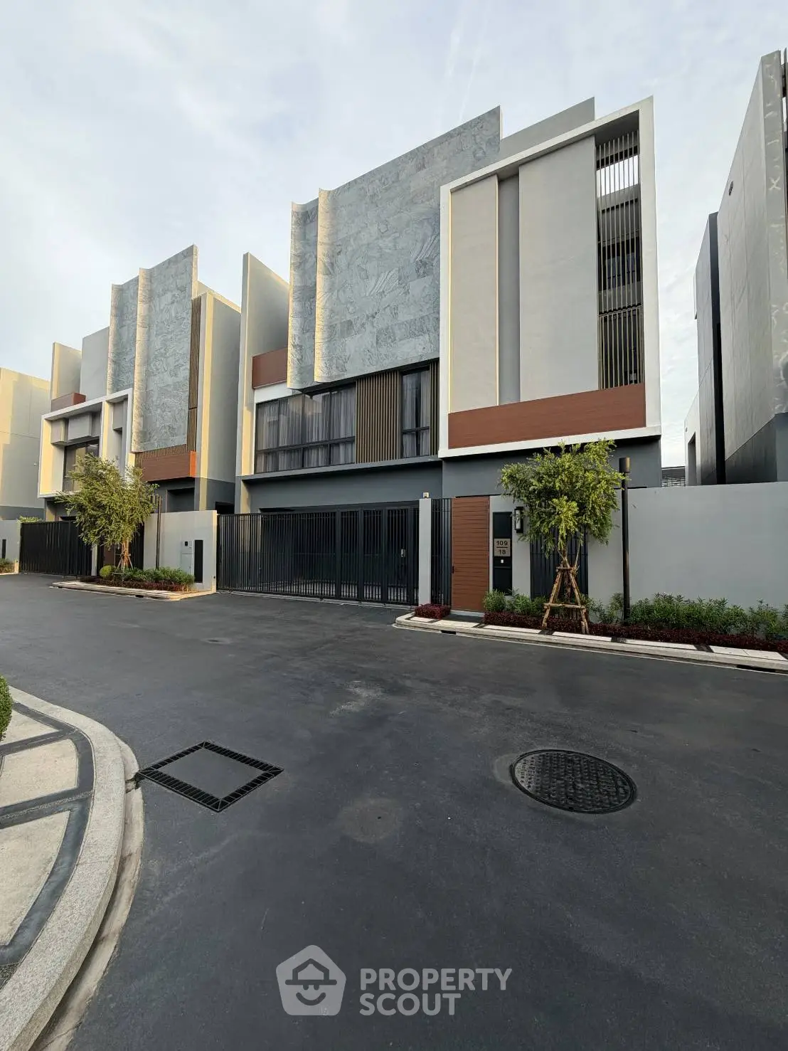 Modern luxury townhouse exterior with sleek design and spacious driveway