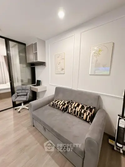 Modern living room with stylish gray sofa and chic decor in a contemporary apartment.