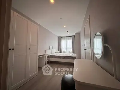 Spacious bedroom with modern furnishings and natural light