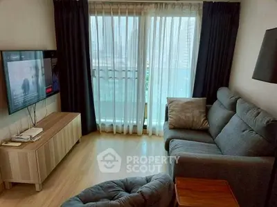 Cozy living room with modern furniture and large window offering city view