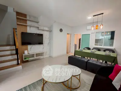 Modern living room with stylish decor and open dining area