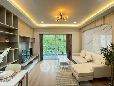 Modern living room with elegant lighting and large windows overlooking greenery