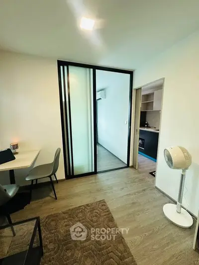 Modern apartment interior with sliding glass door and stylish furnishings
