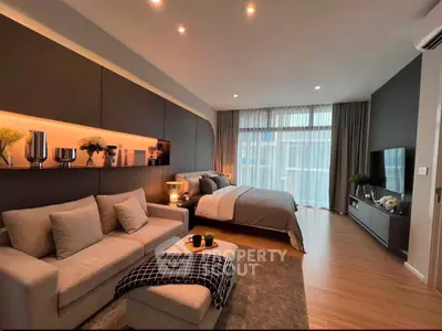 Luxurious modern bedroom with stylish decor and cozy seating area, perfect for relaxation and comfort.