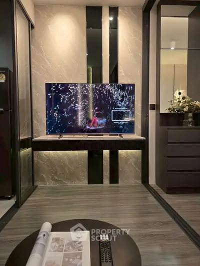 Modern living room with sleek TV setup and elegant decor, perfect for stylish urban living.