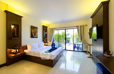 Luxurious bedroom with modern decor and garden view, featuring elegant furnishings and natural light.