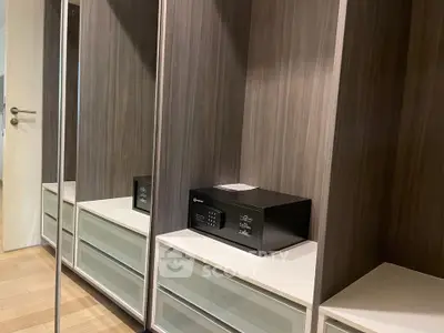 Spacious modern storage unit with mirrored doors and built-in safe in a stylish interior.