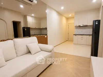 Modern living room with open kitchen layout and sleek design