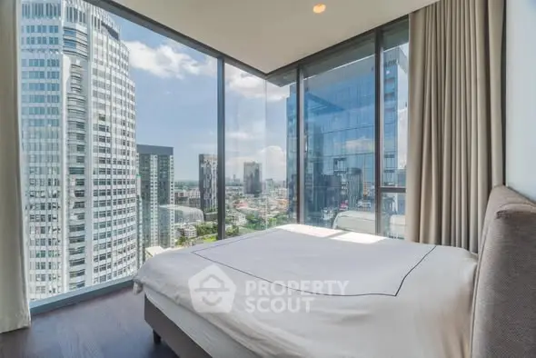 Luxurious bedroom with panoramic city view in modern high-rise apartment
