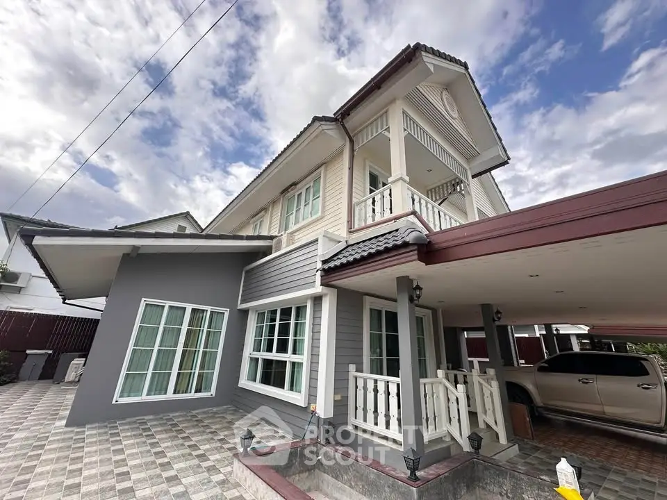 Stunning two-story house with modern design and spacious carport, perfect for family living.