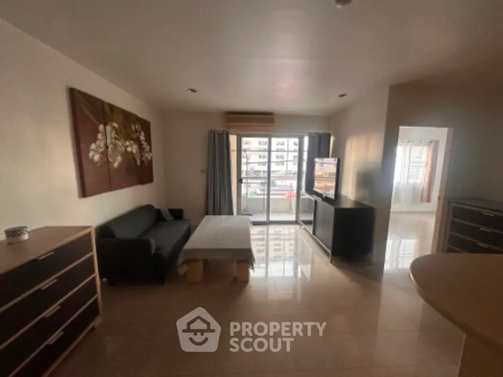 Spacious living room with modern decor and large window view