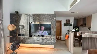 Modern living room with stylish marble TV wall and open kitchen layout