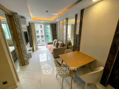 Modern living room with elegant decor and balcony view in a stylish apartment.