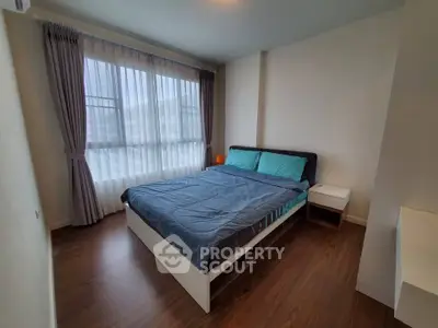 Cozy bedroom with large window and modern furnishings