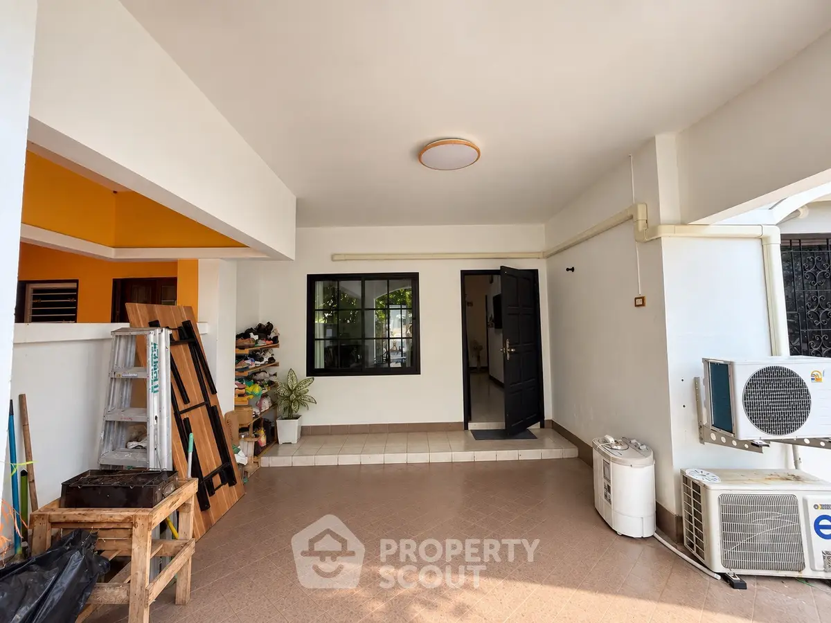 Spacious covered patio with modern design and air conditioning unit