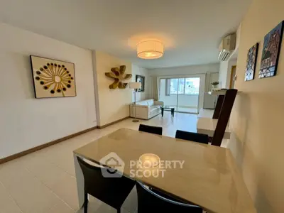 Spacious modern living room with elegant decor and large windows offering city views.