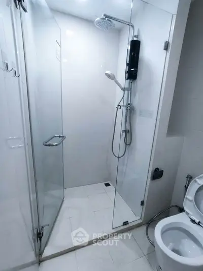 Modern bathroom with glass shower enclosure and sleek fixtures