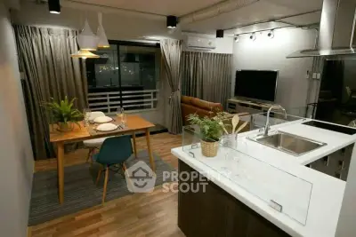 Modern open-layout living room and kitchen with stylish decor and dining area.