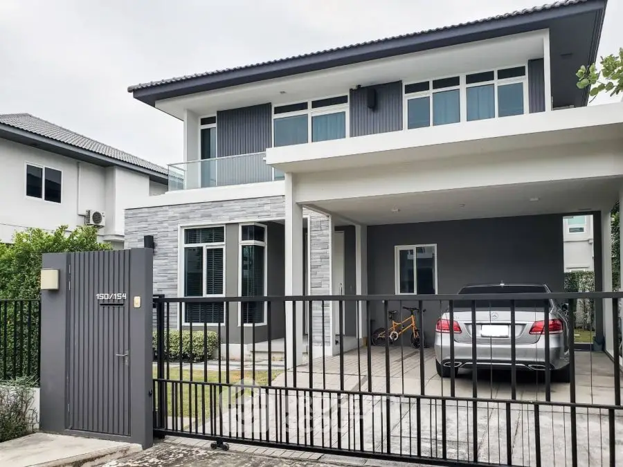 Modern two-story house with carport and sleek design in suburban neighborhood.