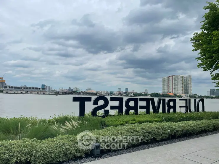 Stunning riverside view with lush greenery and city skyline, perfect for serene living.
