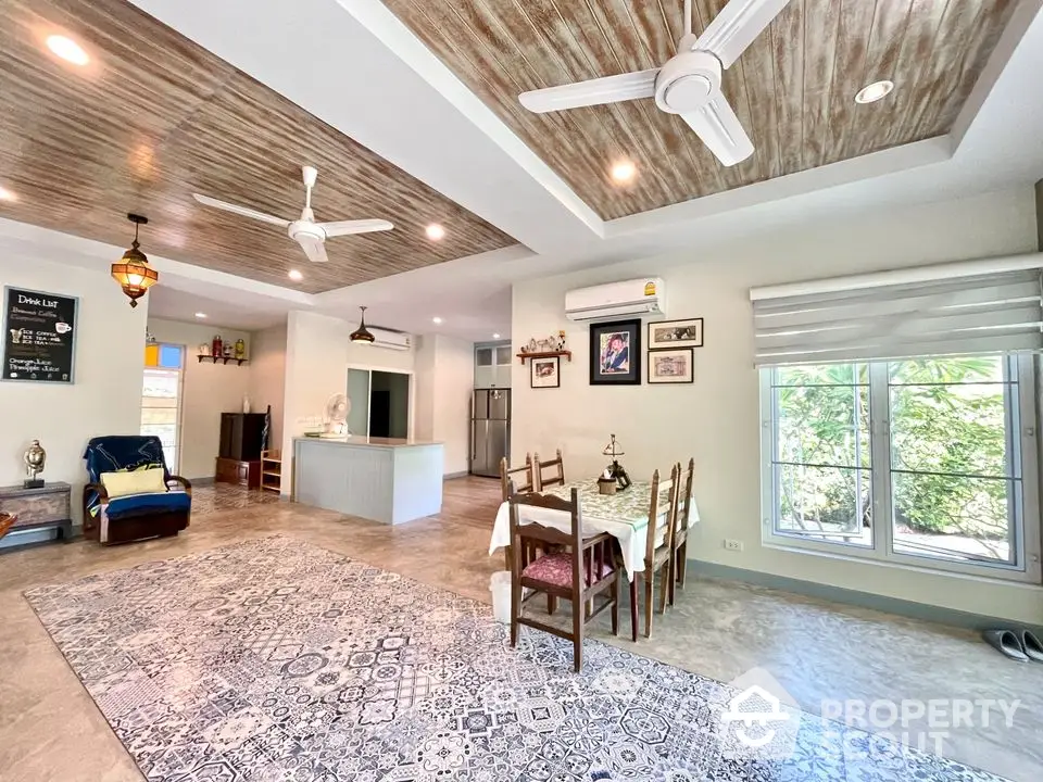 Spacious open-layout living and dining area with modern decor and natural light.