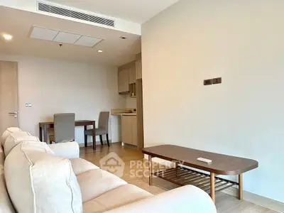 Modern living room with cozy sofa and dining area in open layout apartment.