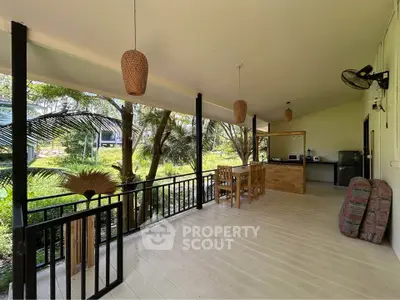 Spacious outdoor patio with dining area and lush garden view, perfect for relaxation and entertaining.