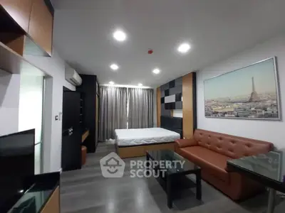 Modern studio apartment with stylish decor and cityscape artwork