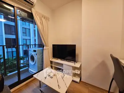 Cozy living room with modern decor and balcony view in urban apartment
