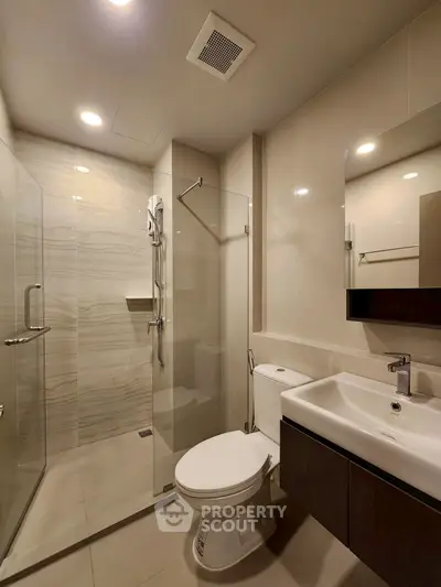 Modern bathroom with glass shower and sleek fixtures, ideal for contemporary living.