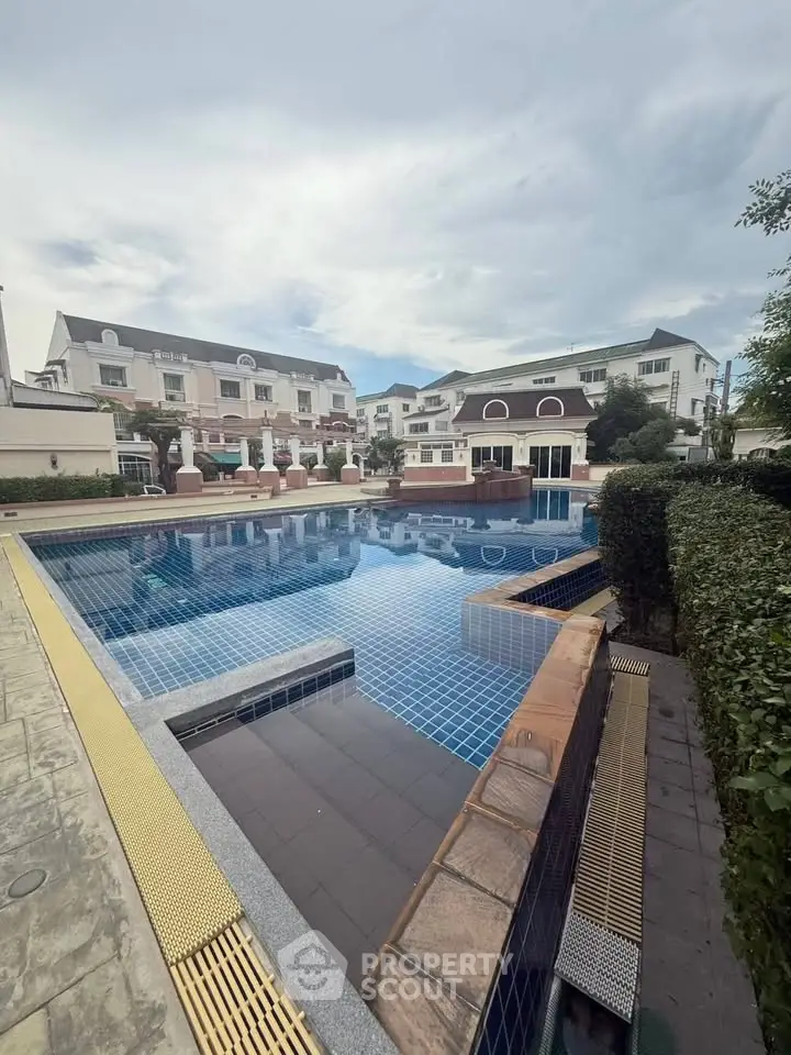 Luxurious residential complex with a stunning outdoor pool and elegant architecture.
