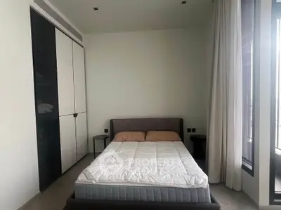 Modern bedroom with sleek design, featuring a cozy bed and large wardrobe, perfect for urban living.