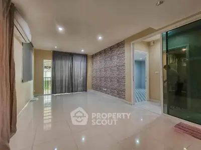 Spacious modern living room with tiled flooring and large windows