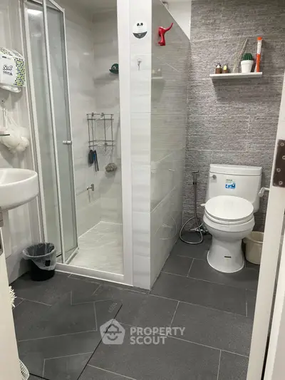 Modern bathroom with sleek shower and contemporary fixtures in stylish apartment.