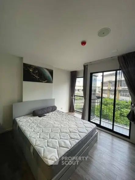 Modern bedroom with large windows and balcony view in a stylish apartment