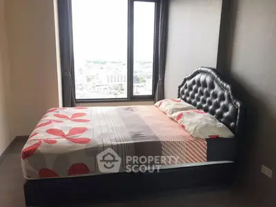 Modern bedroom with large window offering stunning city view