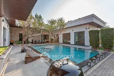 Luxurious modern villa with private pool and stylish outdoor seating area.