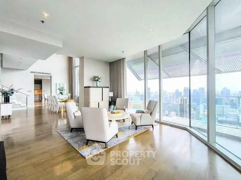 Luxurious high-rise living room with panoramic city views and elegant modern decor.