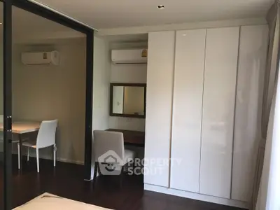 Modern bedroom with sleek wardrobe and air conditioning unit