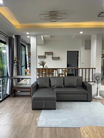 Modern living room with sleek gray sofa and stylish decor