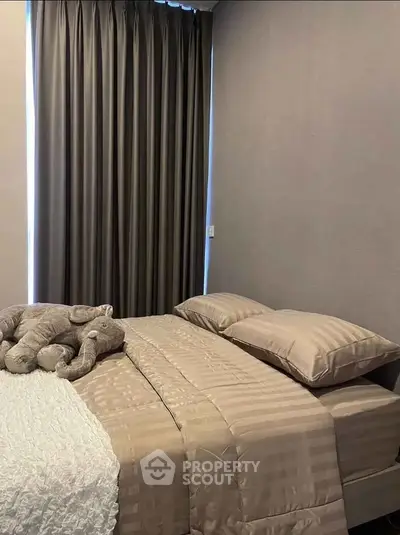 Cozy bedroom with elegant bedding and plush elephant decor