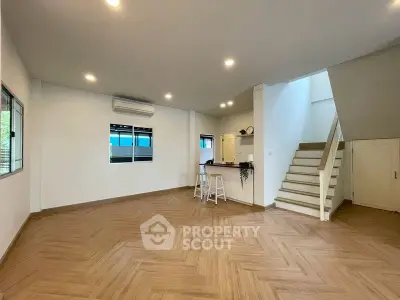Spacious modern living room with open layout and stylish wooden flooring