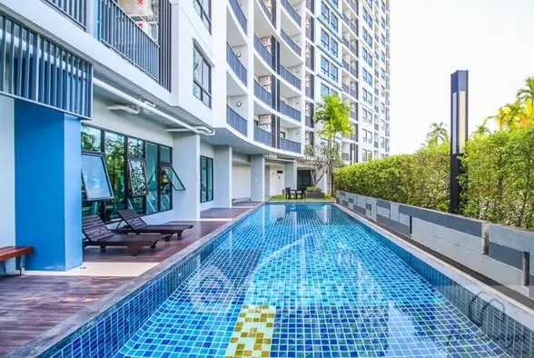 Luxurious condominium with a stunning outdoor pool and modern architecture.