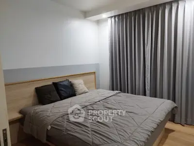 Modern bedroom with cozy bedding and elegant curtains