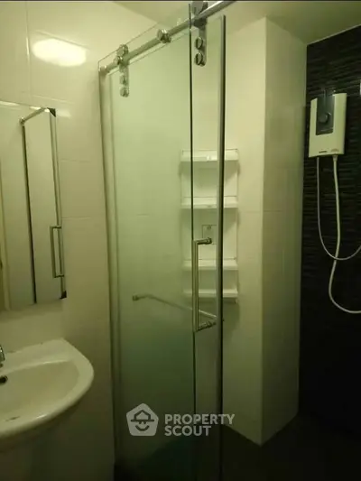 Modern bathroom with glass shower enclosure and sleek fixtures