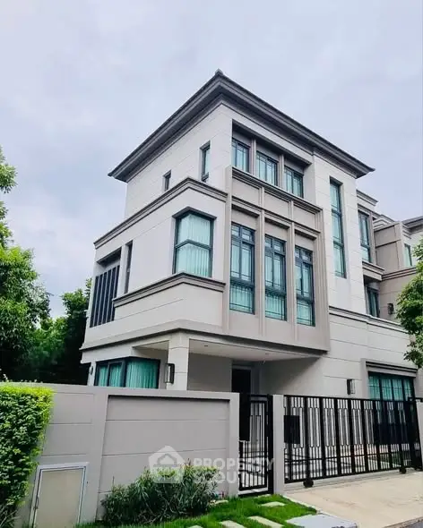 Modern luxury house with sleek design and large windows in a serene neighborhood.